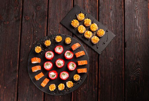 Rolls set with fish shrimp and caviar sushi with chopsticks - asian food and japanese cuisine concept top view