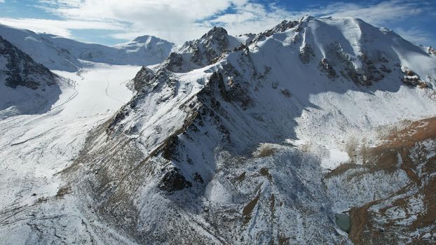 An ancient snow glacier among high mountains.