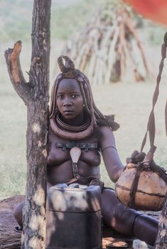 May 15, 2005. portrait of unidentified Himba woman with the traditional hairstyle, necklace and the typical ochre tinted skin. Epupa Falls, Kaokoland or Kunene Province, Namibia, Africa
