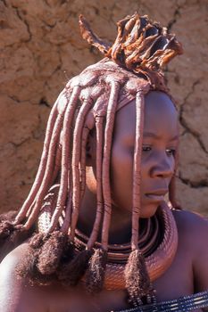 May 15, 2005. portrait of unidentified Himba woman  with the traditional hairstyle, necklace and the typical ochre tinted skin. Epupa Falls, Kaokoland or Kunene Province, Namibia, Africa