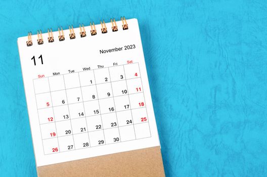 The November 2023 Monthly desk calendar for 2023 year on blue background.