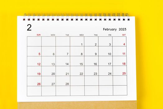 The February 2023 Monthly desk calendar for 2023 year on yellow background.