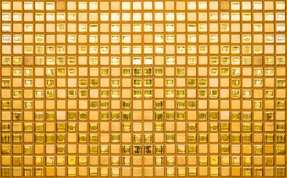 The Luxury gold mosaic tiles background texture as background. Golden shiny ceramic tile wall pattern. High resolution photo.