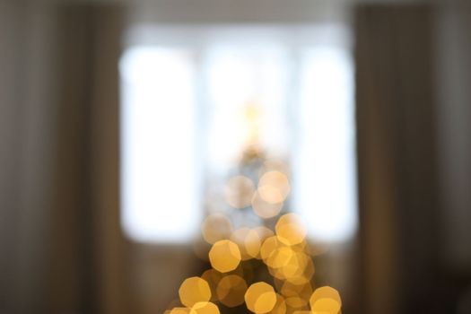 christmas tree out of focus. abstract christmas background with defocused bokeh lights