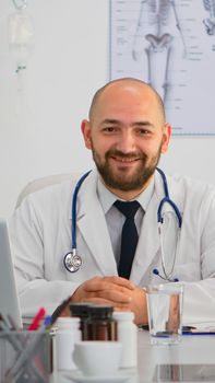 Doctor looking at camera smiling during brainstorming