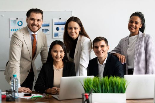 team of young business people smiling looking at camera at workplace