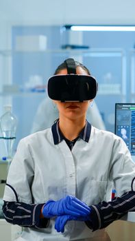 Laboratory doctor experiencing virtual reality using vr goggles