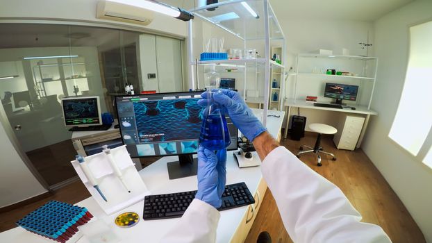 POV of medical scientist working with DNA scan image