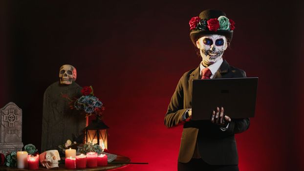 Goddess of death surfing internet with laptop