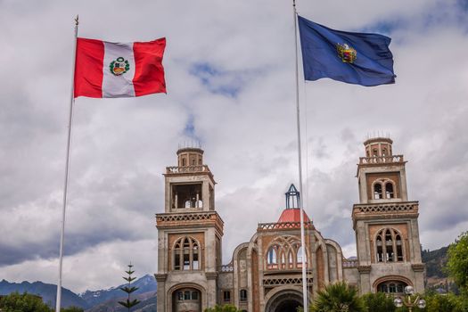 Huaraz colonial cathedral and Peru flag , Ancash province, Peru