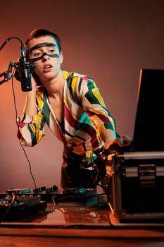 Woman performer producing techno music at mixer