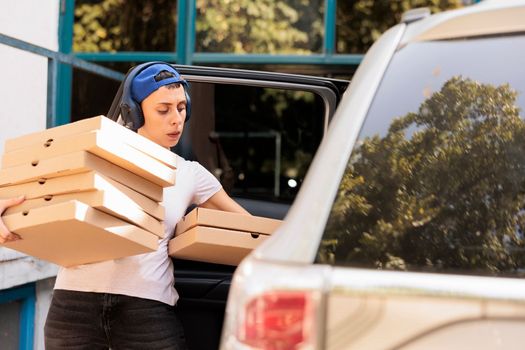 Courier carrying pizza to office by car
