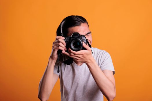Photographer taking photos on professional dslr camera