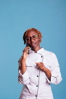 Professional female cook using mobile device