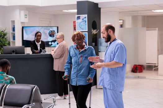 Hospital administrative staff guiding african american patient