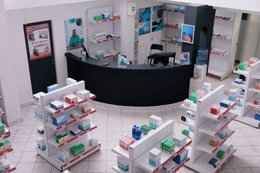 Empty pharmacy with nobody in it having shevles with pharmaceutical products