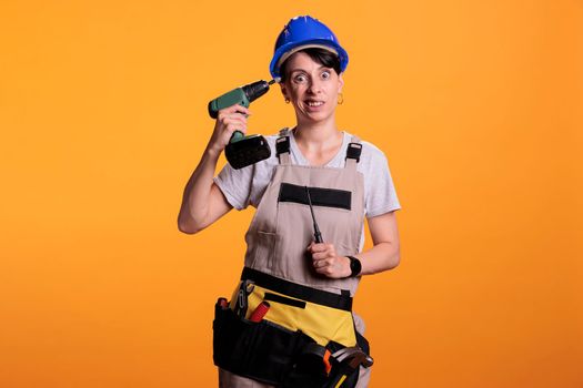 Woman repair employee holding power drill gun