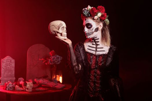 Spooky goddess of death looking at skull