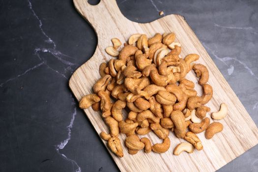 cashew nut on a chopping board on table 