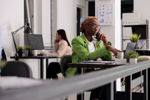 Employee having phone call in coworking open space