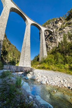 Swiss train over Landwasser Viaduct bridge in the alps, Graubunden valley, Switzerland
