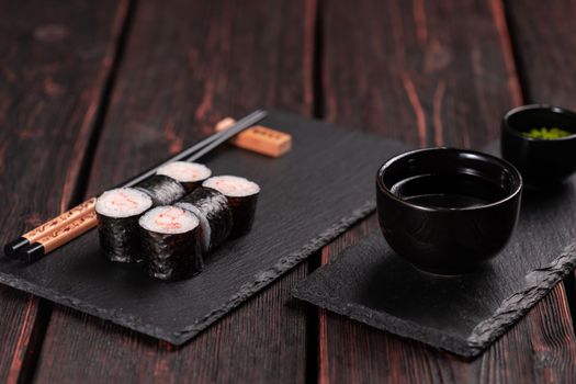 Maki shrimp sushi close-up. Shrimp fillet stuffing wrapped in rice and nori seaweed. Japanese cuisine