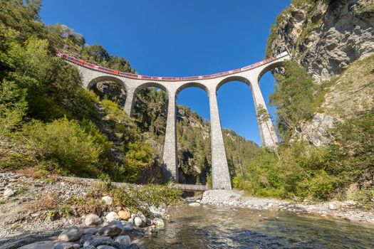 Swiss train over Landwasser Viaduct bridge in the alps, Graubunden valley, Switzerland