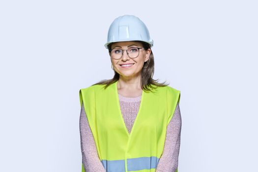 Female industrial construction worker in hardhat vest on white background