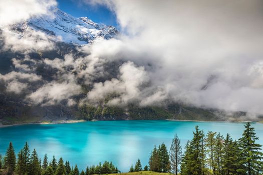 Misty Oeschinensee, Oeschinen lake, on Bernese Oberland swiss alps, Switzerland