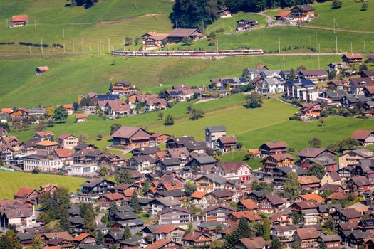 Train and lungern village in the Swiss Alps at sunny day, Switzerland
