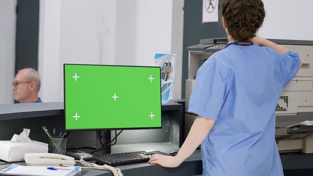 Medical nurse working with greenscreen on computer
