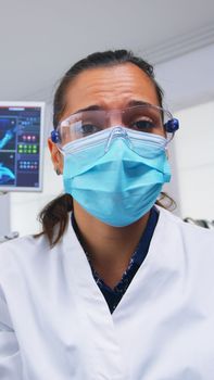 Patient point of view to dentist in protective mask holding tool