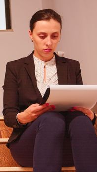Confused overworked business woman reading documents