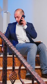Businessman reading project deadline during phone call