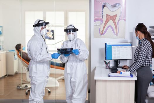 Stomatology team dressed up in ppe suit during global pandemic