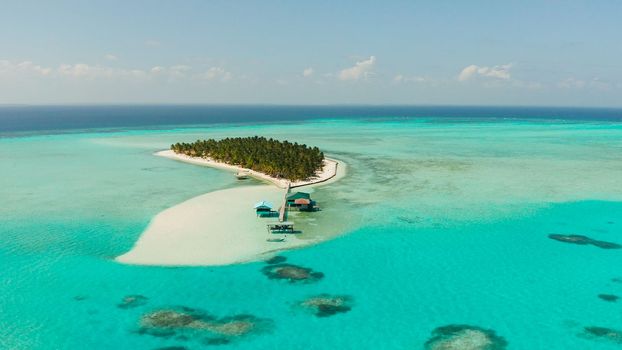 Tropical island with a beach on the atoll. Onok Island Balabac, Philippines.