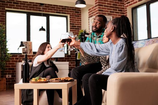 African american man toasting with female mixed ethnicity friends