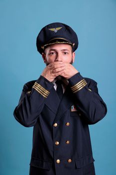 Airliner captain covering mouth with hands