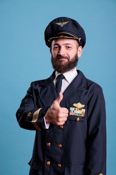 Smiling airplane aviator showing thumb up gesture