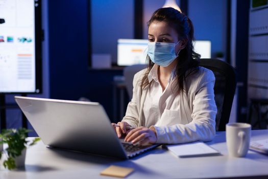 Close up of businesswoman with face mask checking emails