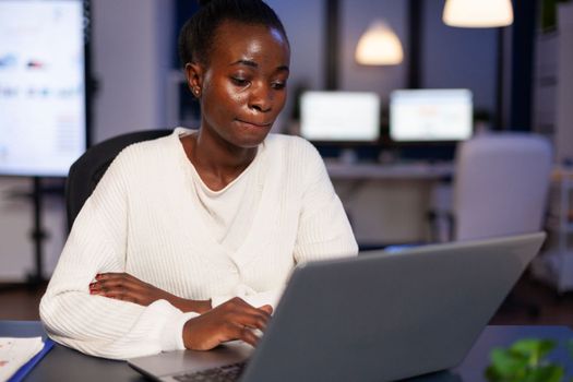 Overworked african american businesswoman reading business email