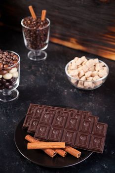 Chocolate tablet next to other candies