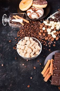 Brown sugar in a glass bowl next to candies and sweets