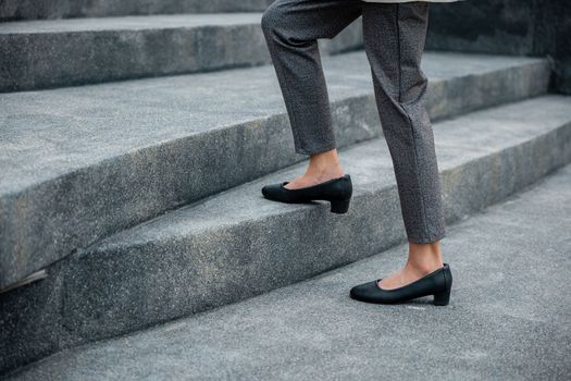Closeup legs of businesswoman hurry up walking on stairway