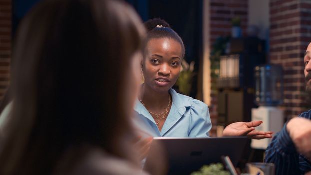 Coworkers business meeting, african american employee speaking close up