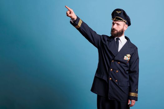 Airplane pilot pointing at sky with index finger