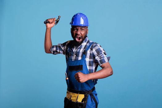 Builder aggressive facial expression holding hammer