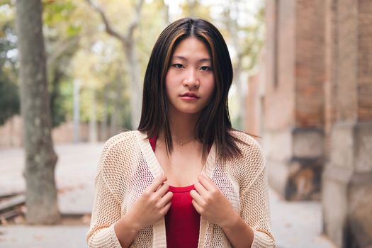 serious young asian woman looking at camera