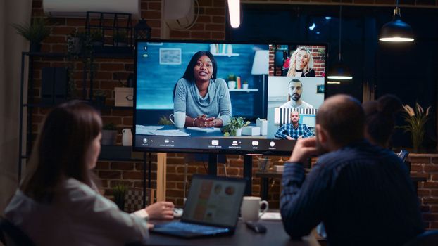Employees planning strategy with remote team in teleconference app