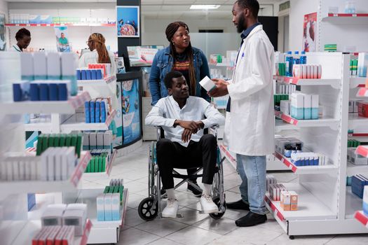 Man in wheelchair and social worker choosing prescription treatment
